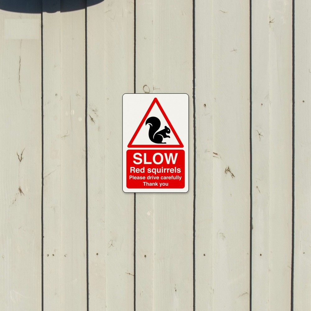 Slow Red Squirrels Please Drive Carefully Thank You sign in use